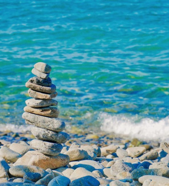 Stacked stones by beach - Easthead Counselling